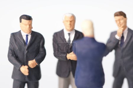 Photo for Miniature businesspeople figurines on white background - Royalty Free Image