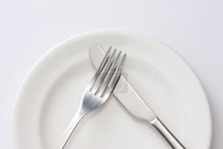 Photo for Fork and knife on plate - Royalty Free Image
