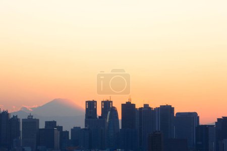 Photo for Beautiful sunset over city. silhouettes of skyscrapers over sunset sky background - Royalty Free Image