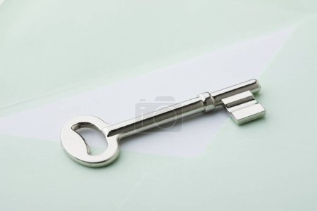 Photo for Envelope and steel key  on  background, close up - Royalty Free Image