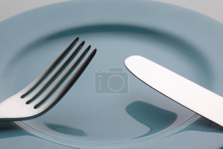 Photo for Fork and knife on plate - Royalty Free Image