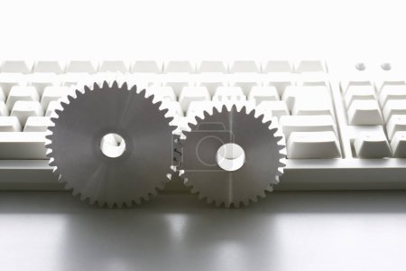 Photo for Computer keyboard and gears on white background. Computer settings concept - Royalty Free Image