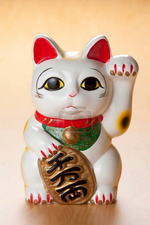 Photo for Maneki neko lucky cat  on background, close up - Royalty Free Image