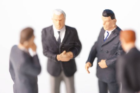 Photo for Miniature businesspeople figurines on white background - Royalty Free Image