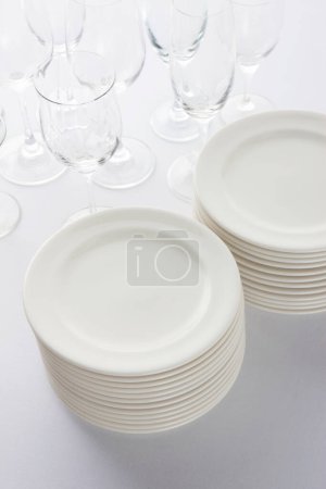 Photo for Empty clean dishes on a white table. - Royalty Free Image
