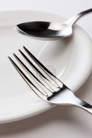 Photo for Fork and spoon on plate - Royalty Free Image