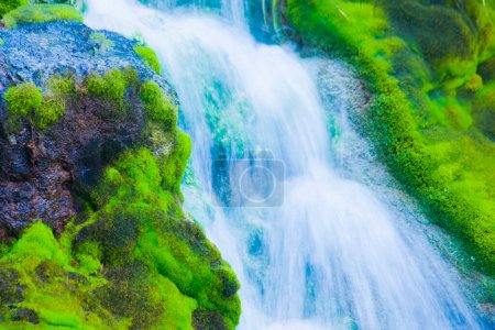 Téléchargez les photos : Belle cascade avec mousse verte poussant sur des pierres - en image libre de droit