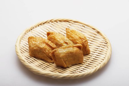 close up view of seasoned rice wrapped In fried tofu bags