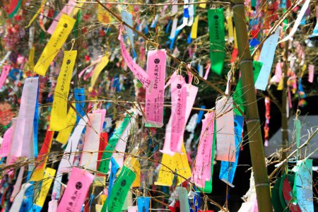 Photo for Decorations and wishes on strips of paper hanging during Tanabata or star festival - Royalty Free Image