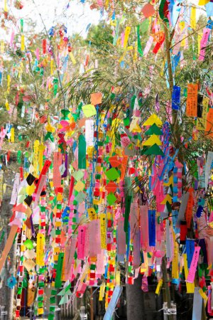 Photo for Decorations and wishes on strips of paper hanging during Tanabata or star festival - Royalty Free Image