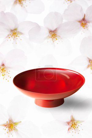 Photo for Red bowl for Japanese sake and blooming cherry flowers, close up view - Royalty Free Image