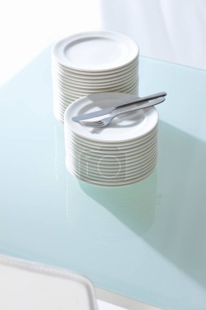 Photo for Clean white plates and cutlery on table - Royalty Free Image