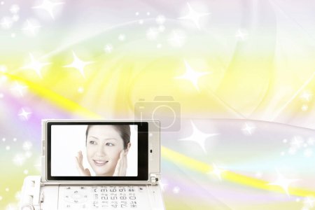 Photo for Mobile phone screen with beautiful asian woman image - Royalty Free Image
