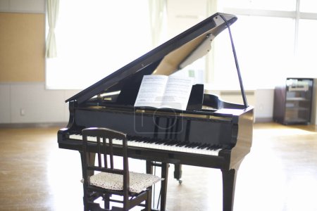 Photo for Black piano standing in classroom view - Royalty Free Image