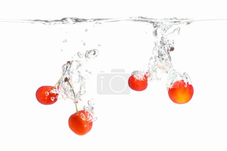Photo for Cherry berries in a splash of juice on a white background - Royalty Free Image