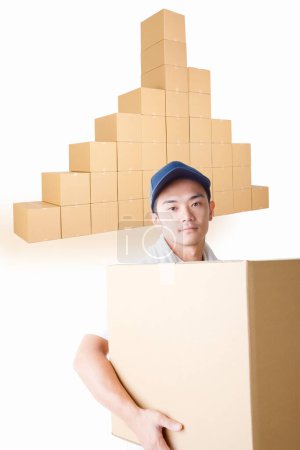 Photo for Delivery man with  cardboard boxes in warehouse - Royalty Free Image