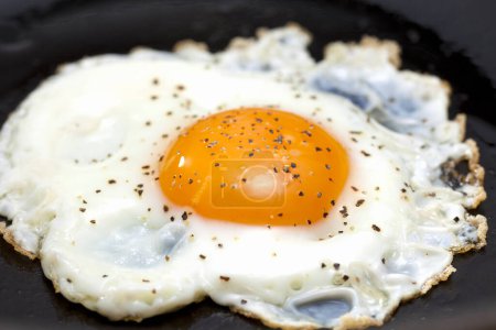 Photo for Close-up view of tasty fried egg in frying pan - Royalty Free Image