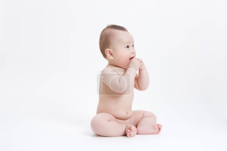 Photo for Cute little baby sitting on white background - Royalty Free Image