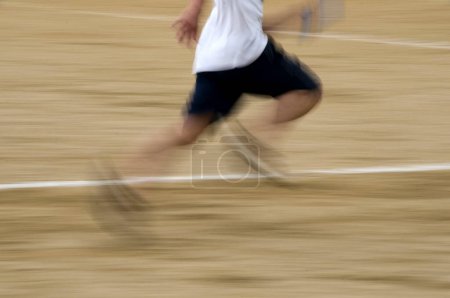 Photo for Blurred motion view of runner running on race stadium - Royalty Free Image