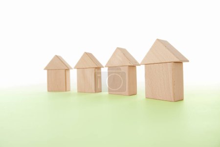 Photo for Houses models and wooden cubes on  background - Royalty Free Image