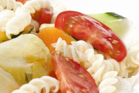 Photo for Pasta salad with tomatoes, cucumbers and carrots - Royalty Free Image