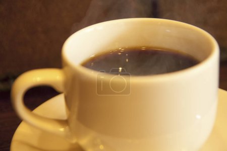 Photo for Hot coffee cup on  table background, close up - Royalty Free Image