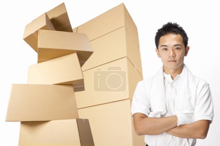 Photo for Asian delivery man with cardboard boxes - Royalty Free Image