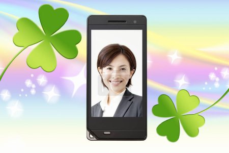 Photo for Technology and communication concept background of mobile phone screen with beautiful asian woman image - Royalty Free Image
