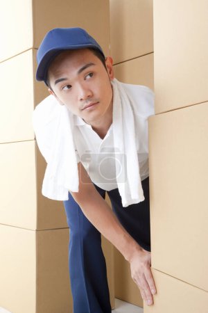 Photo for Asian man with cardboard boxes in warehouse - Royalty Free Image