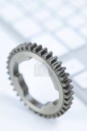 Photo for A Gear And A Pc Keyboard - Royalty Free Image