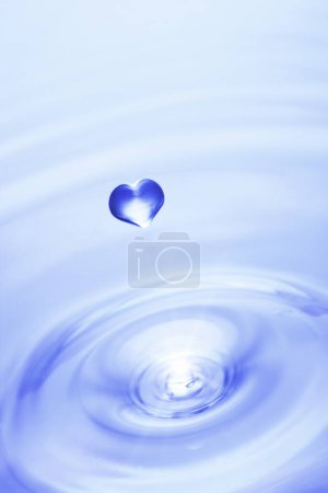 Photo for Heart-shaped drop of water on blue background - Royalty Free Image