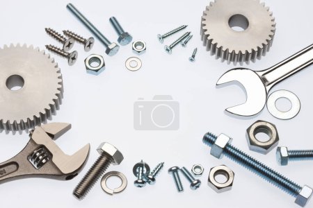 Photo for Close-up view of metal bolts and gears on white background - Royalty Free Image