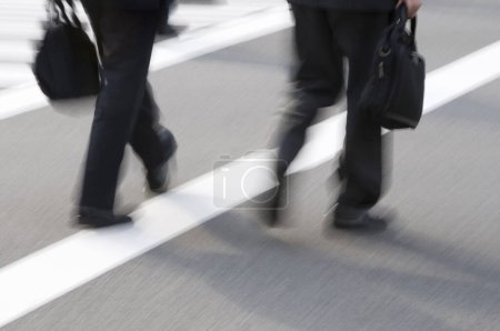 Photo for Blurred motion view of legs of people walking in city - Royalty Free Image
