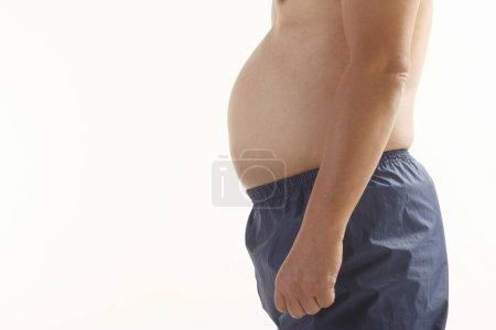 Photo for Man showing fat belly studio shot - Royalty Free Image