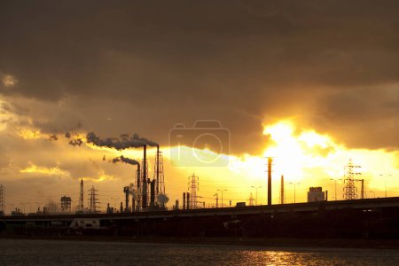 Photo for Industrial factory with pipes against sunset sky - Royalty Free Image