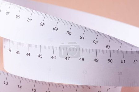 Photo for Close-up view of tape measure on beige background - Royalty Free Image