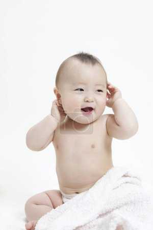 Photo for Studio portrait of adorable Asian baby in diaper on white background - Royalty Free Image