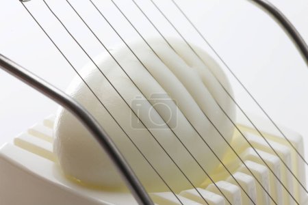 Photo for Cutting boiled egg with slicer, close up view - Royalty Free Image