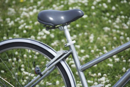 Photo for Bicycle at flower meadow background view - Royalty Free Image
