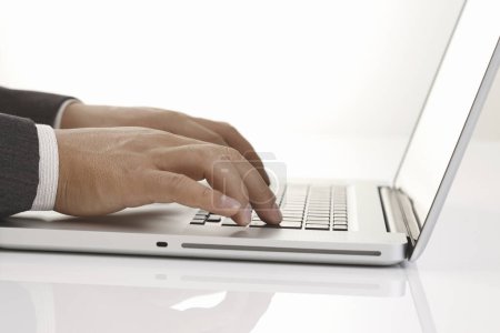 Photo for Close up of hands typing on laptop computer - Royalty Free Image