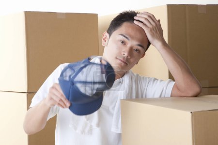 Photo for Asian man with cardboard boxes on background - Royalty Free Image