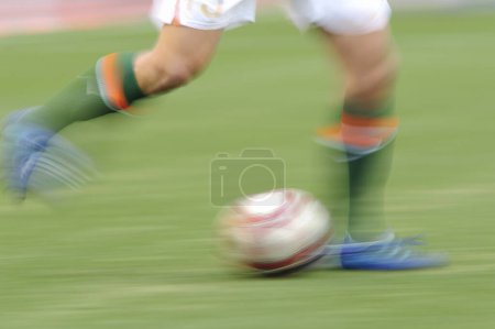 Photo for Close up soccer player legs kicking ball - Royalty Free Image