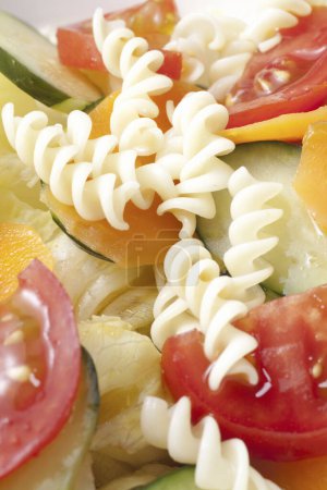 Photo for Pasta salad with tomatoes, cucumbers and carrots - Royalty Free Image