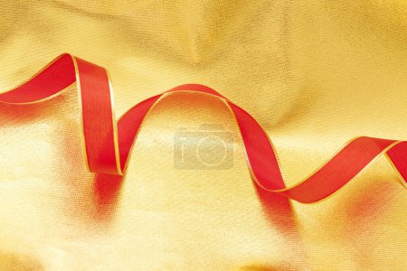 Photo for Golden and red satin ribbon on background, close up - Royalty Free Image