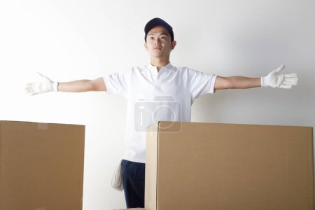 Photo for Delivery man with cardboard boxes and white background - Royalty Free Image