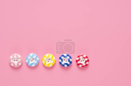Photo for Top view of colorful buttons on pink background - Royalty Free Image