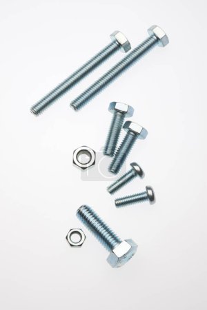 Photo for Close-up view of metal bolts and nuts on white background. - Royalty Free Image