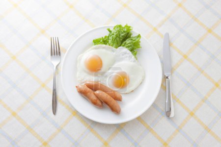 Photo for Fried rice, eggs, fried sausage on a plate, close up - Royalty Free Image
