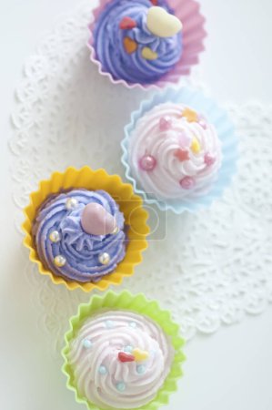 Photo for Close-up view of delicious sweet cupcakes with icing - Royalty Free Image
