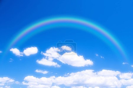 Photo for Rainbow and white clouds in the sky - Royalty Free Image